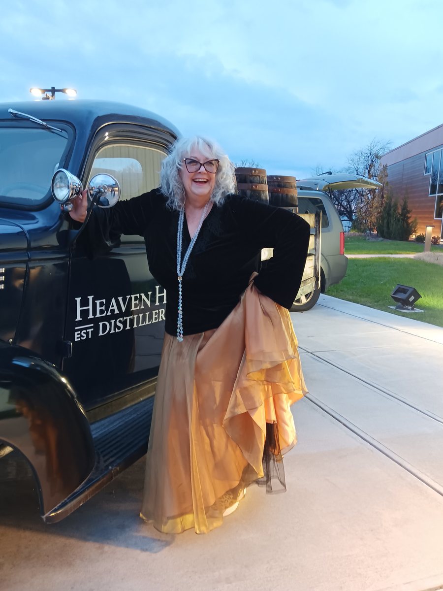 Debbie Ables standing by a vintage truck at dusk in Bardstown, Kentucky